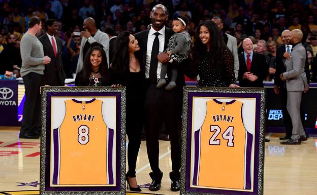 Kobe Bryant y su familia, junto a las dos camisetas. /Afp